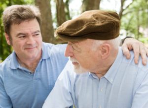 Senior father with his middle aged son. Focus on the elderly man.